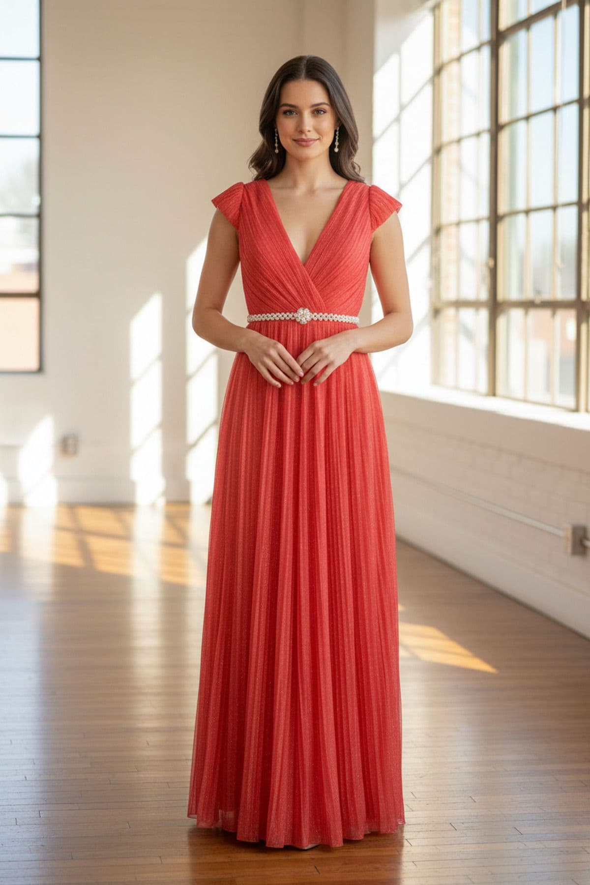A coral evening gown featuring a pleated skirt and a beaded waistline, perfect for formal occasions and modest Christian events.
